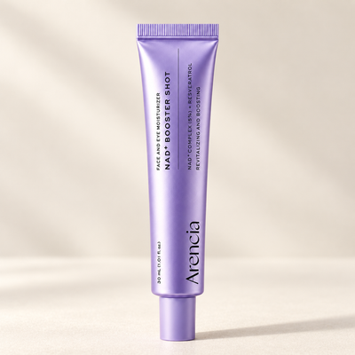 Single lavender NAD+ Booster Shot tube on a warm ivory surface in natural side light