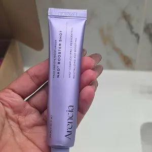 Customer holding her partially used NAD+ Booster Shot tube